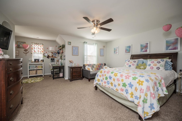 carpeted bedroom featuring multiple windows, ceiling fan, and baseboards