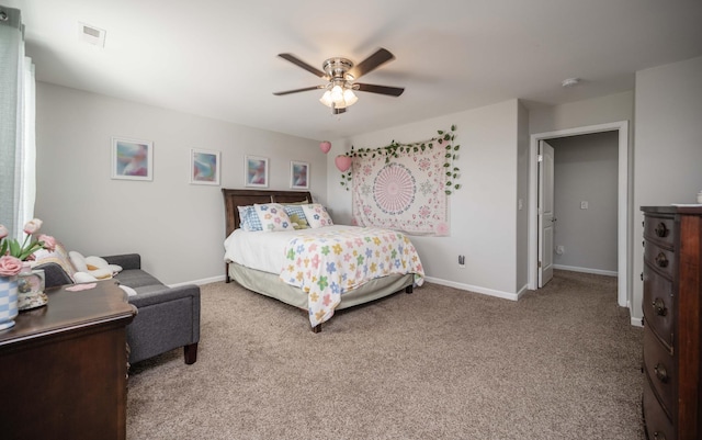 carpeted bedroom featuring ceiling fan and baseboards