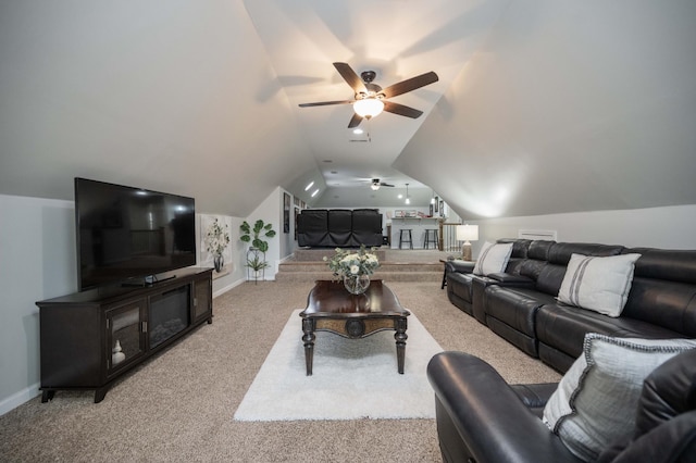 living area with a ceiling fan, light colored carpet, vaulted ceiling, and baseboards