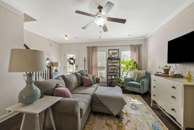 living room with crown molding, dark wood-type flooring, and ceiling fan