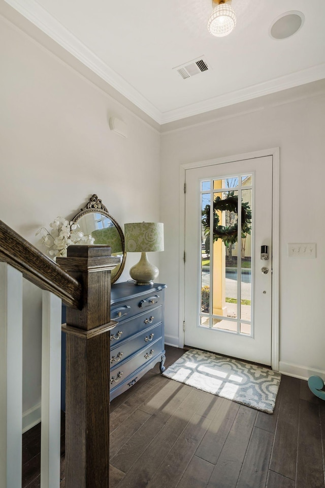 doorway featuring dark wood-type flooring and ornamental molding