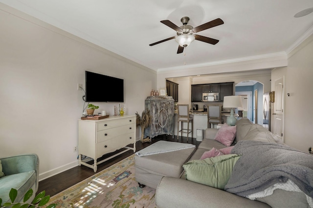 living room featuring ceiling fan, crown molding, and dark hardwood / wood-style flooring