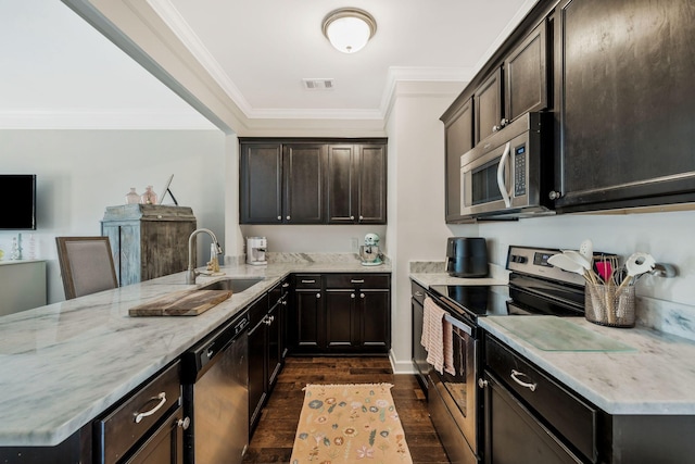 kitchen featuring sink, light stone counters, appliances with stainless steel finishes, crown molding, and dark hardwood / wood-style floors