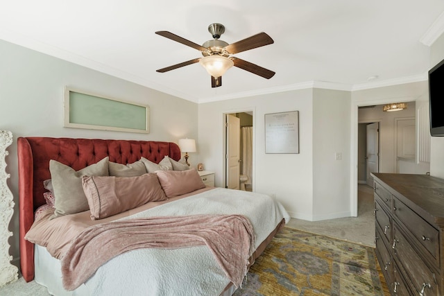 bedroom featuring dark carpet, ceiling fan, crown molding, and connected bathroom