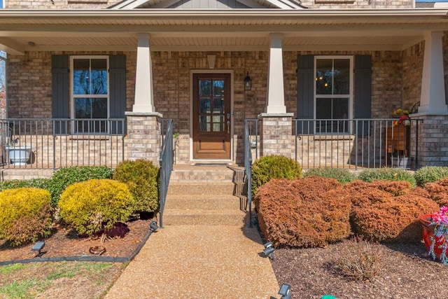 7144 Triple Crown Ln, Fairview, TN 37062 - doorway to property with board and batten siding, brick siding, and a porch