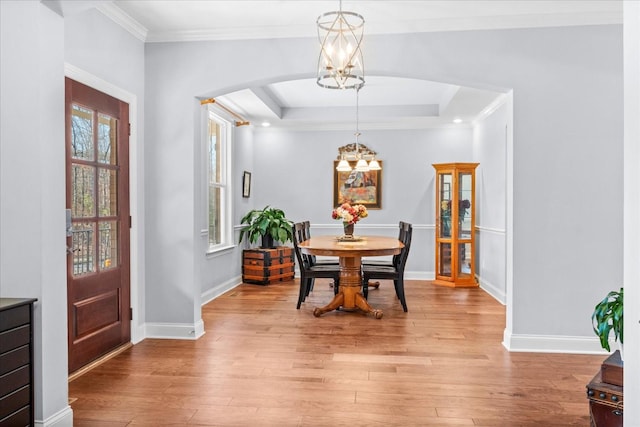7144 Triple Crown Ln, Fairview, TN 37062 - dining area with crown molding, light wood-style flooring, baseboards, and an inviting chandelier