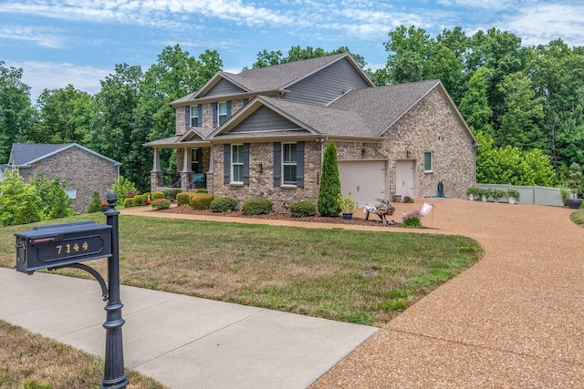 7144 Triple Crown Ln, Fairview, TN 37062 - craftsman-style home featuring a garage, brick siding, a porch, and a front yard