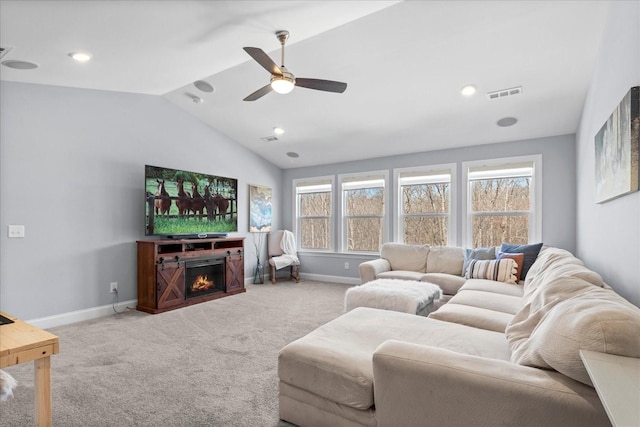 7144 Triple Crown Ln, Fairview, TN 37062 - carpeted living area with visible vents, baseboards, a ceiling fan, a lit fireplace, and vaulted ceiling
