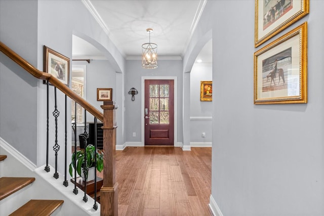 7144 Triple Crown Ln, Fairview, TN 37062 - foyer entrance featuring a notable chandelier, crown molding, stairway, wood finished floors, and baseboards