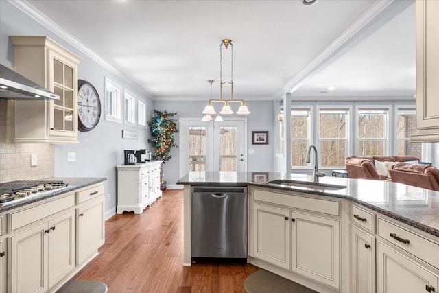 7144 Triple Crown Ln, Fairview, TN 37062 - kitchen featuring glass insert cabinets, cream cabinets, stainless steel appliances, pendant lighting, and a sink