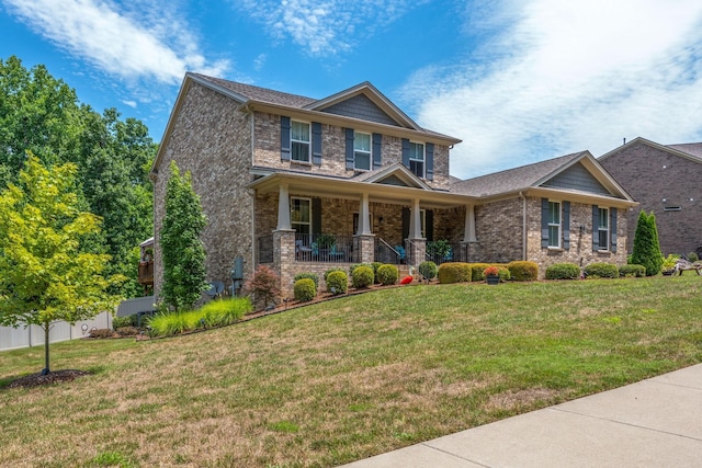 7144 Triple Crown Ln, Fairview, TN 37062 - craftsman inspired home featuring covered porch, brick siding, a front yard, and fence