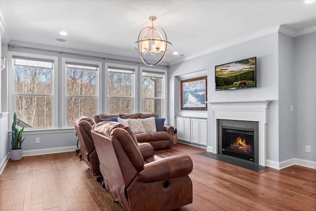 7144 Triple Crown Ln, Fairview, TN 37062 - living room featuring a fireplace with flush hearth, baseboards, wood finished floors, and crown molding