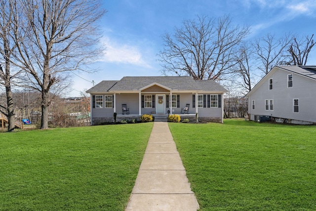 view of front of house with central air condition unit, a front lawn, and a porch