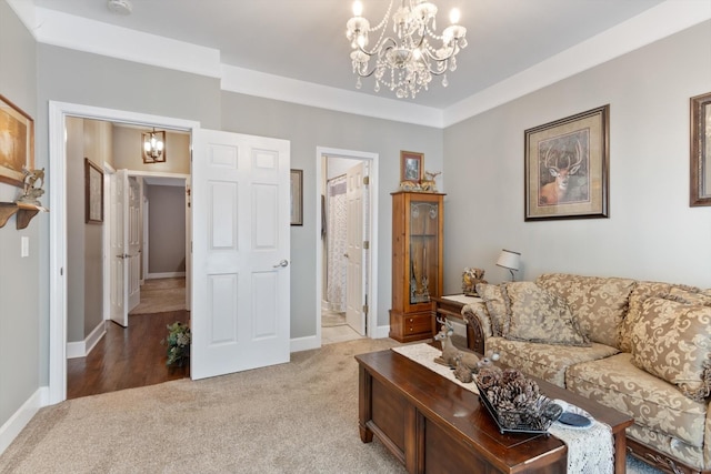 carpeted living room featuring a chandelier