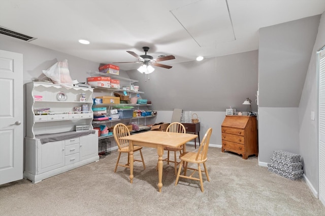 dining room with vaulted ceiling and light colored carpet