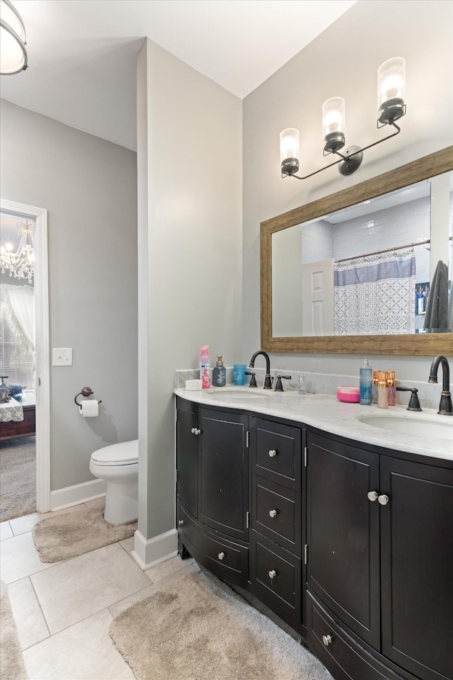 bathroom with vanity, toilet, and tile patterned floors