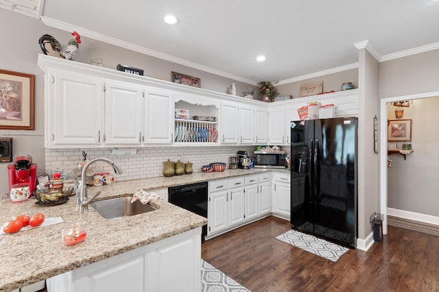 kitchen featuring light stone countertops, white cabinets, black appliances, crown molding, and sink