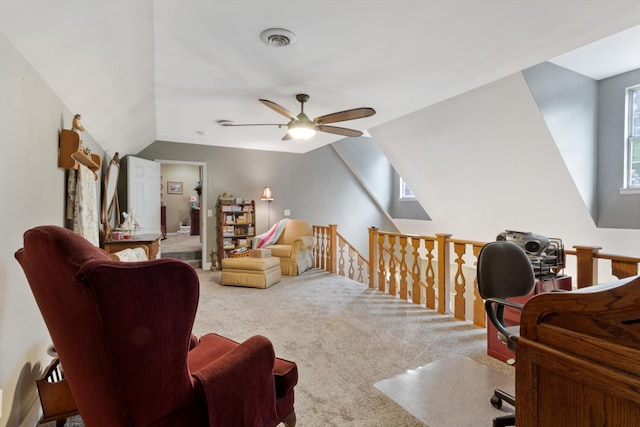 interior space featuring vaulted ceiling, ceiling fan, and carpet flooring