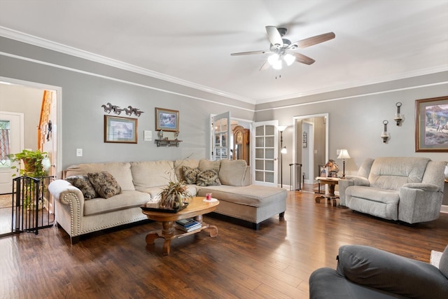 living room featuring ceiling fan, ornamental molding, and dark hardwood / wood-style flooring