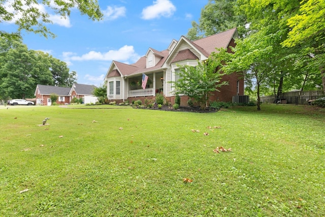 view of front of home featuring central AC and a front yard