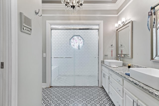 bathroom with ornamental molding, vanity, and a shower with door