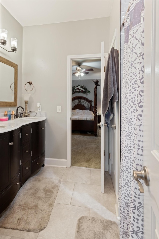 bathroom with ceiling fan, vanity, and tile patterned flooring