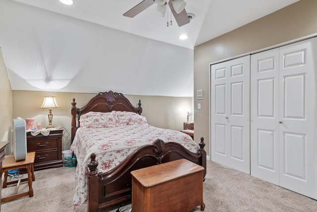 bedroom featuring light carpet, a closet, ceiling fan, and vaulted ceiling