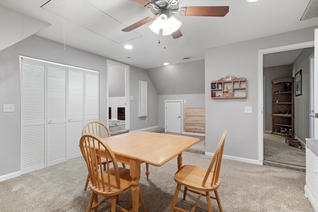 dining room featuring lofted ceiling, ceiling fan, and light colored carpet