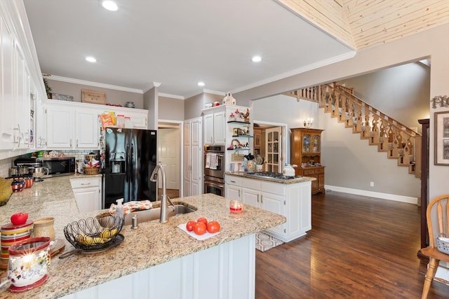 kitchen featuring stainless steel appliances, light stone countertops, sink, white cabinetry, and kitchen peninsula