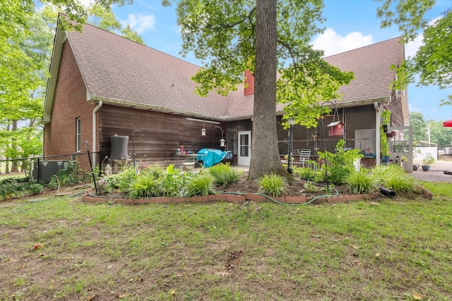 rear view of property with a yard