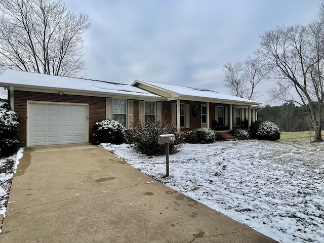 ranch-style home with a garage and covered porch