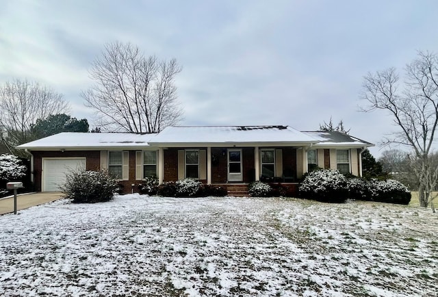 ranch-style house featuring covered porch and a garage