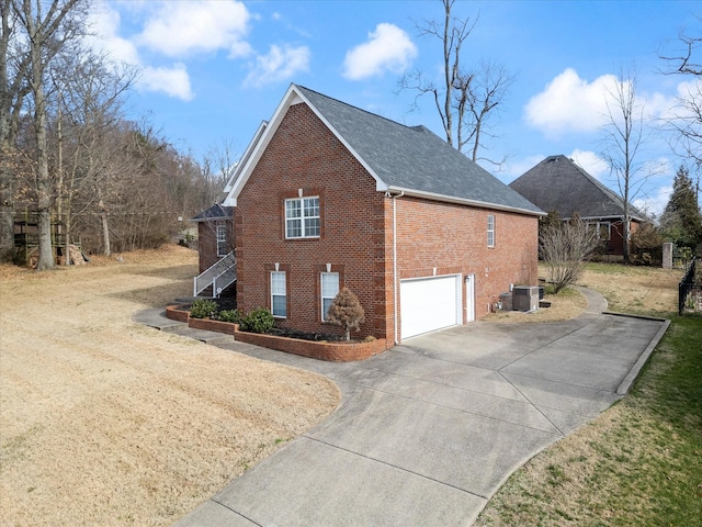 view of side of property featuring a garage and cooling unit