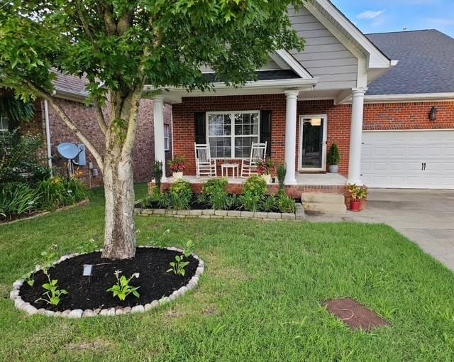 craftsman inspired home with covered porch, a garage, and a front lawn