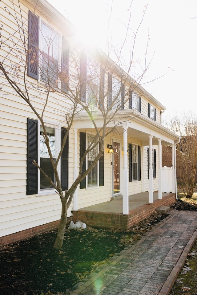 view of side of property featuring a porch