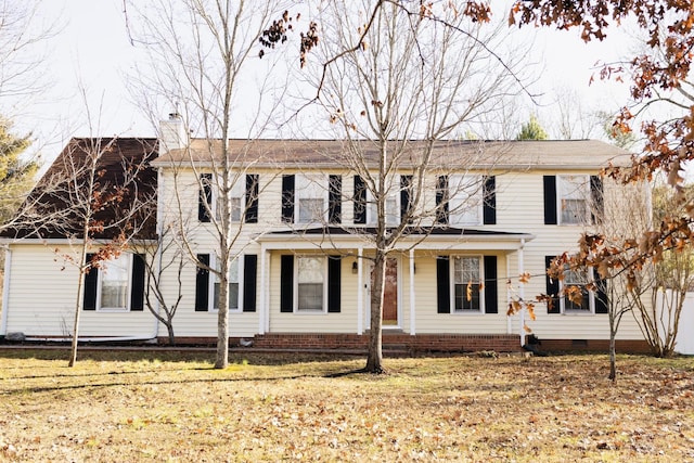 colonial home with a front lawn