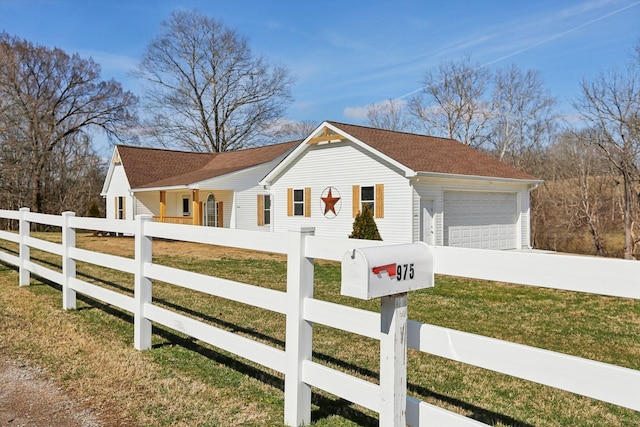 view of front of home with a front lawn and a garage