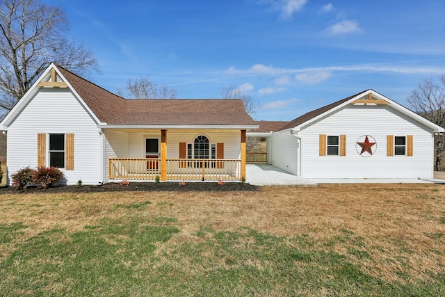 rear view of property with a lawn and a porch