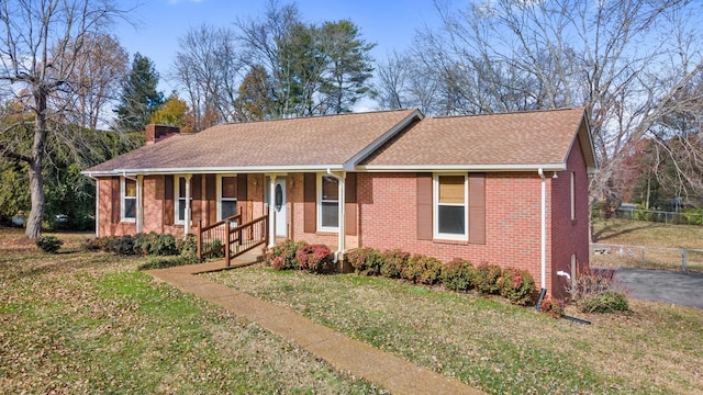 ranch-style house with covered porch and a front yard