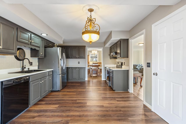 kitchen featuring appliances with stainless steel finishes, sink, tasteful backsplash, and dark hardwood / wood-style floors