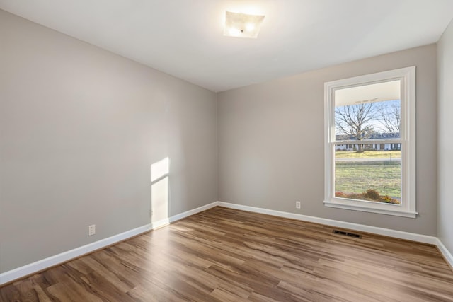 unfurnished room with hardwood / wood-style floors