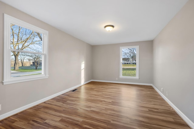 spare room with wood-type flooring