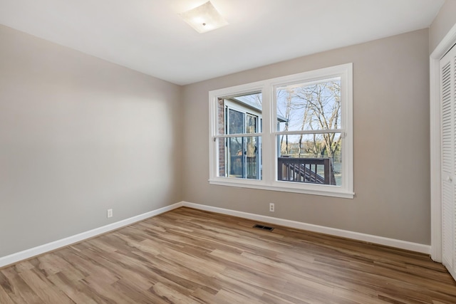 spare room featuring light wood-type flooring