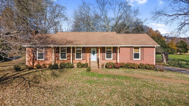 single story home with covered porch and a front yard