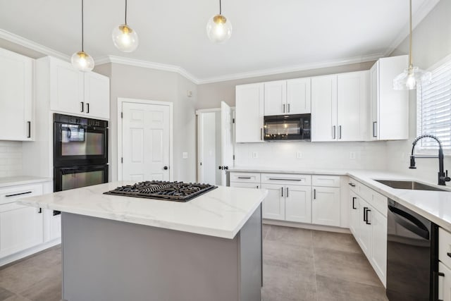 kitchen with sink, light stone counters, a kitchen island, black appliances, and white cabinets