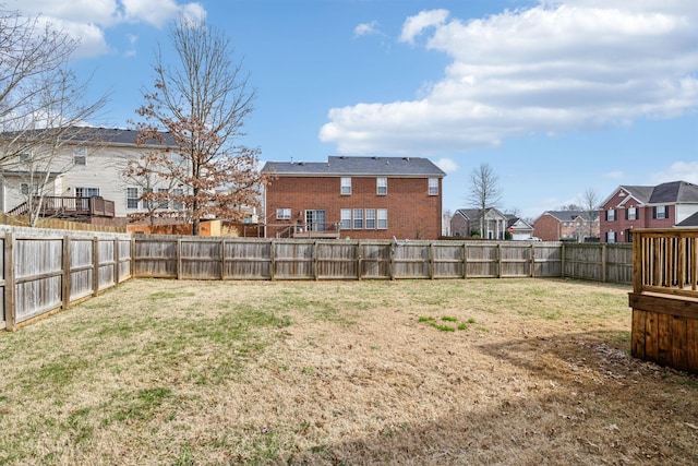 view of yard featuring a fenced backyard and a residential view