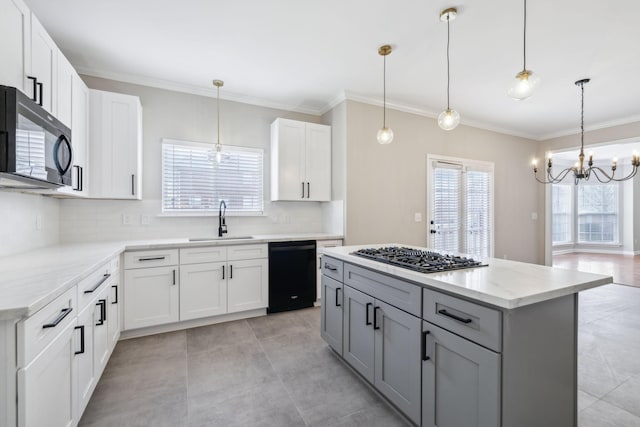 kitchen featuring gray cabinetry, white cabinets, black appliances, decorative light fixtures, and sink