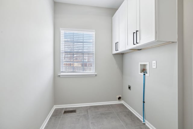 laundry room featuring hookup for a washing machine, visible vents, cabinet space, electric dryer hookup, and baseboards