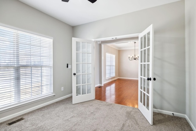 doorway to outside featuring baseboards, visible vents, carpet flooring, and french doors