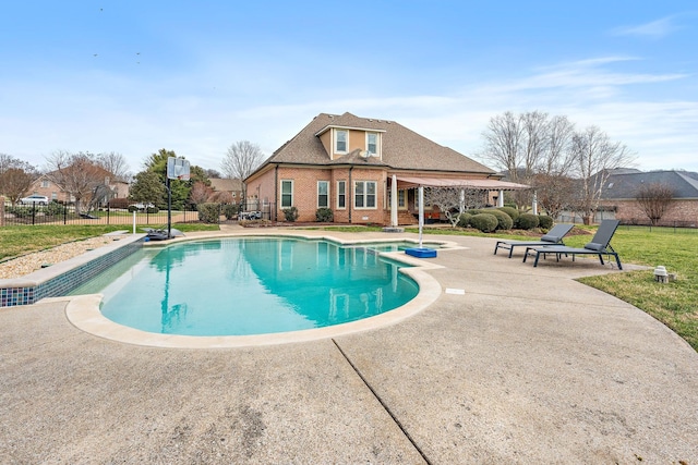 view of pool with a patio and a lawn